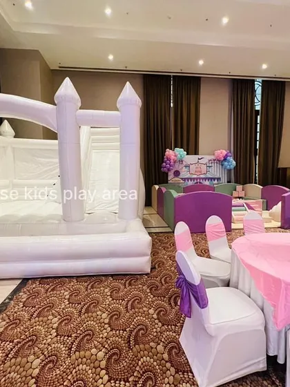 Another view of the white bouncy castle, showing how it can be a major attraction at any indoor event.