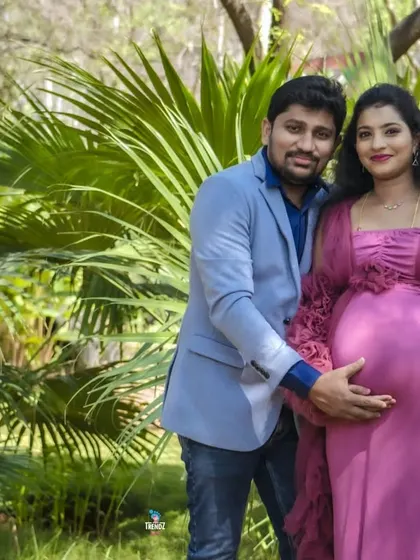 A happy couple in a beautiful park setting announcing they are having a boy. The "It's a boy" sign is a fun prop that adds a personal touch to the portrait.