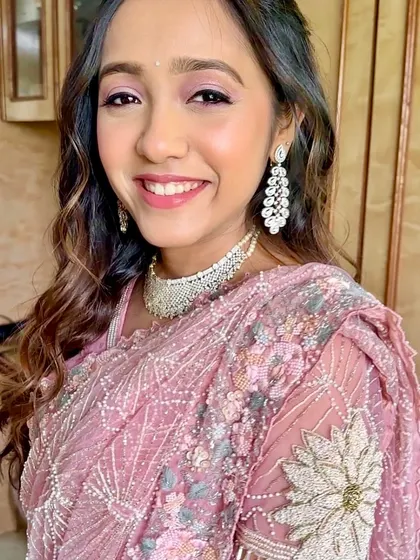 A close-up of the pretty in pink look, with shimmering eyeshadow and a radiant smile.