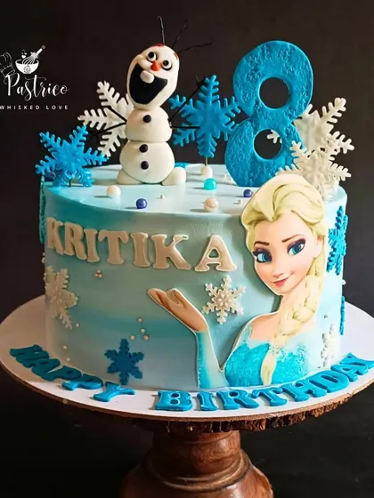 Bringing the magic of Disney's Frozen to life is always a joy. This cake features Elsa and a handcrafted Olaf on a snowy blue landscape, perfect for a fan's birthday celebration.
