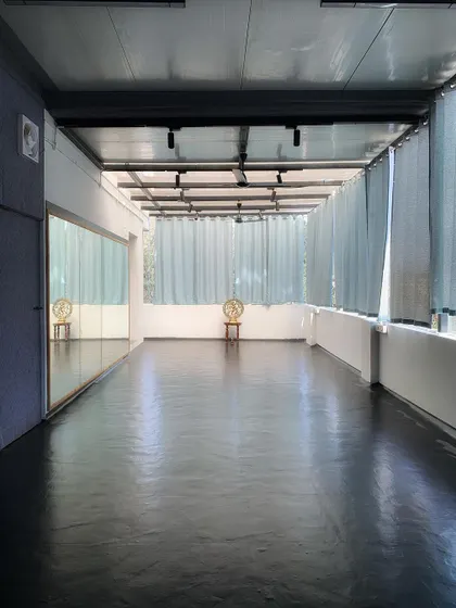 Sunlight streaming into the long studio hall. This bright and airy space is perfect for morning yoga and dance sessions.