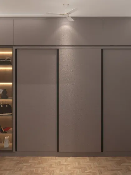 We designed this large sliding-door wardrobe with a built-in, illuminated display case for luxury accessories. The textured finish on the doors adds a layer of subtle elegance.