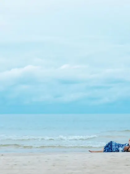 A relaxed moment on the sand, this shot captures the couple enjoying the peaceful ambiance of their beach pre-wedding session.