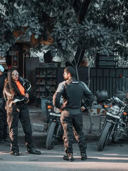 A candid group interaction at the biker meetup. This photo captures the social aspect of these events, with riders chatting and connecting beside their motorcycles.