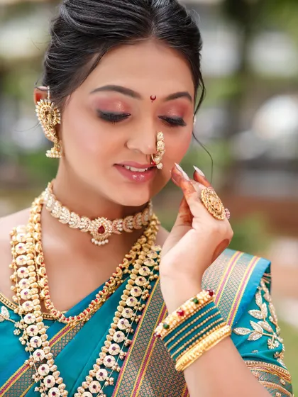A detailed shot of the eye makeup and jewellery.