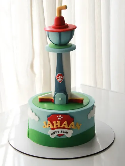 A Paw Patrol cake featuring the iconic lookout tower. The entire structure is part of the cake design, making it a fun and recognizable centerpiece for a fan's birthday.