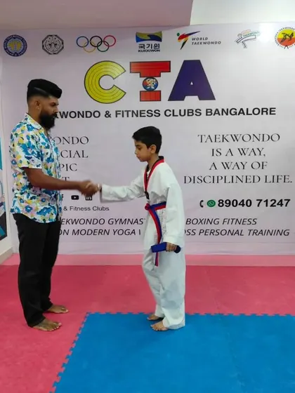 A handshake for a new purple belt.