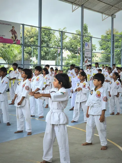 Young karate students stand in formation, showing discipline and focus during their grading exam.