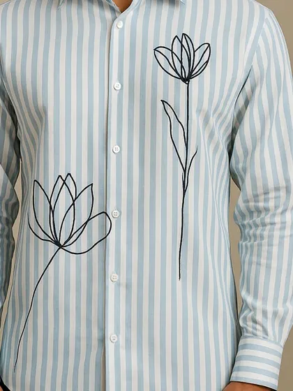 This close-up focuses on the lower part of the shirt, showing the placement of the second flower and the quality of the striped fabric.