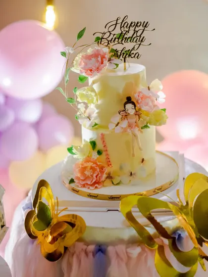 The exquisite fairy-themed birthday cake, featuring delicate, hand-painted details and sugar flowers.
