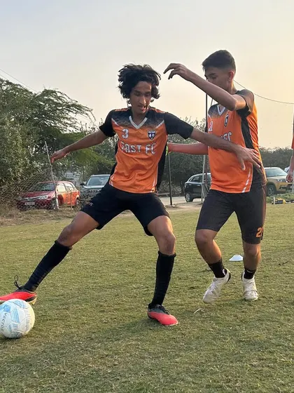 An intense moment during a training match, as one player tries to dispossess another.