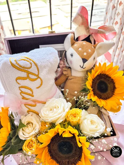 The full view of the stunning sunflower and rose hamper for Alia and Raha, arranged in a beautiful pink trunk box.