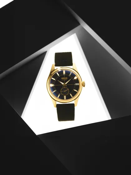 Framing is a powerful tool. Here, I used geometric black shapes to create a window, drawing the eye directly to the gold Argos watch. The contrast between the dark frame and the brightly lit center makes the product the undeniable hero.