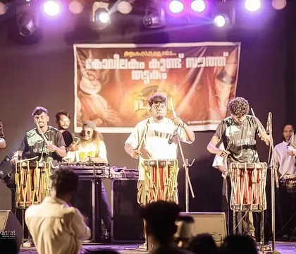 My Chenda artists and I performing on a concert stage. We work together to sync the electronic beats with the live drumming for a seamless and powerful musical fusion.