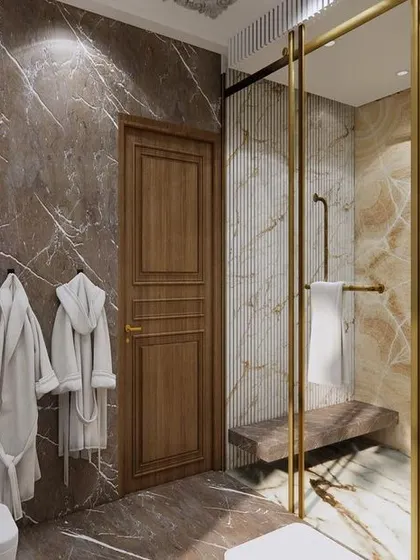 This angle highlights the spacious walk-in shower with a built-in bench. The rich brown marble walls create a warm and inviting atmosphere, turning a daily routine into a luxurious ritual.