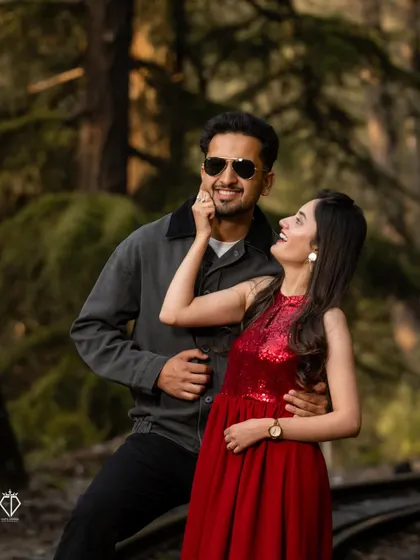 A joyful and candid moment between the couple, framed by the woods along the railway line. Her bright red dress stands out beautifully against the natural tones.