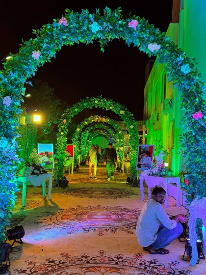 For a Mundan ceremony, I designed this enchanted garden entrance. A series of green arches with flowers leads guests down a path lined with photos of the child, making it a personal and heartwarming experience.