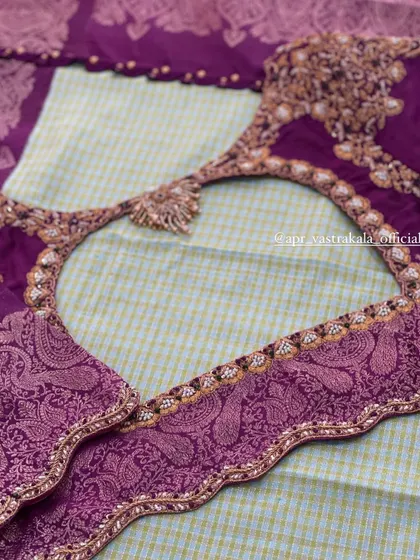 A purple blouse with brocade paisley motifs on the sleeves and back.