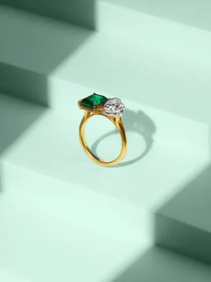 This clean, geometric composition features a stunning emerald and diamond ring against a stepped, mint-green background. Our jewellery photography focuses on sharp details, accurate color, and creative staging to highlight the premium quality of each piece.
