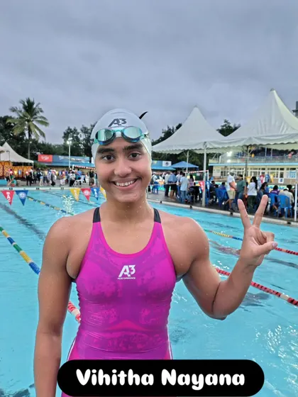 Vihitha Nayana celebrating her victory by the poolside.