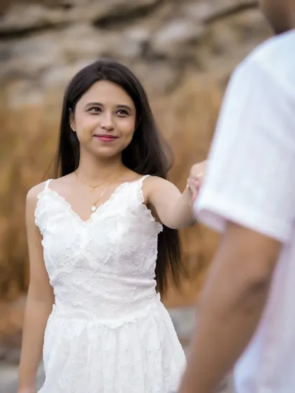 A classic 'follow me to' style shot, with the bride leading the groom, creating a sense of journey and romance.