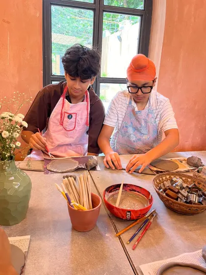 These boys are deeply engaged in their hand-building projects during a 'Clay & Play' session. We provide various tools and cutters to help them bring their creative visions to life.