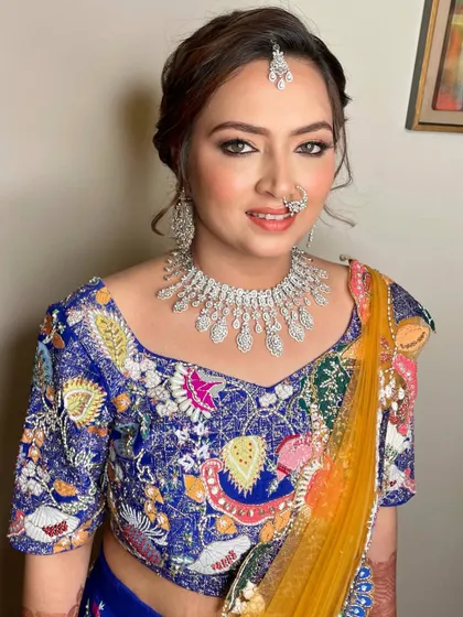 A gorgeous baraat look with a colorful lehenga, smokey eyes, and a diamond nath.