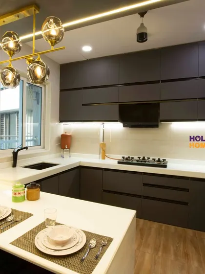 Another view of the open kitchen, showing the breakfast counter and dining setup. This design is perfect for modern families who love to interact while cooking.