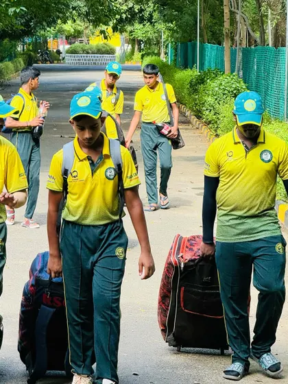 Players and coaches make their way to the ground in Chennai, focused on the day's game.
