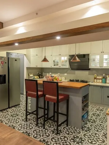 A view from the dining area into the open island kitchen, showcasing the seamless integration of spaces in our Brigade Exotica project.