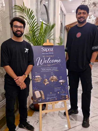 We mark our Sapna Book House appearance beside the welcome board for their Milestone Conference 2026.