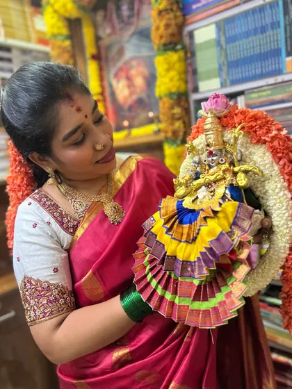 Holding the beautifully draped Gowri idol, ready for the Varamahalakshmi pooja. I teach how to create these intricate saree drapes for the Goddess.