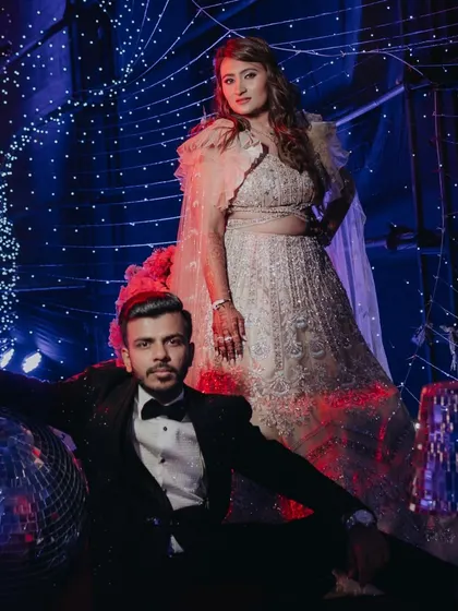 A power pose for a power couple at their grand sangeet. The dramatic lighting and disco ball accents created the perfect glamorous backdrop for their photos.