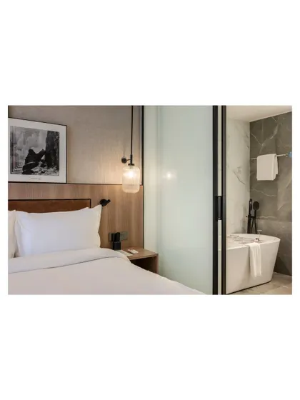 Additional views of the Radisson Resort, Khopoli, showcasing various interior and exterior details, from lobby seating areas and restaurant layouts to guest room configurations and architectural elements.