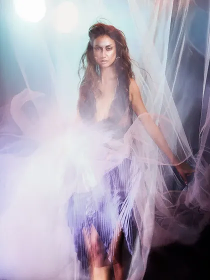 A dreamy, high-fashion shot using long exposure and multiple light sources to create a ghostly, ethereal effect.