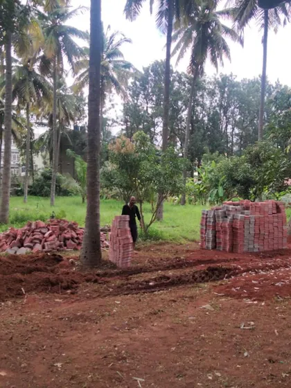 A duplicate image of the wide view of the farm garden site, showing the scale of the materials and the natural setting.