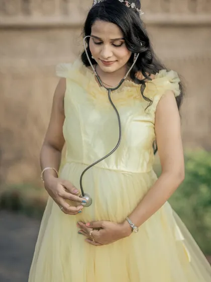 A sweet and creative solo shot, with the mom-to-be listening to her baby bump with a stethoscope.