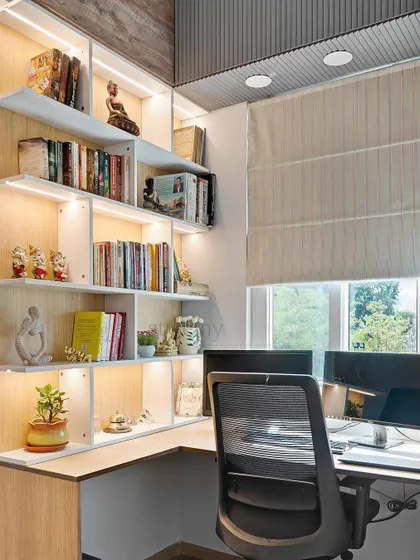 The finished study area, complete with backlit bookshelves that add warmth and highlight the client's collection.