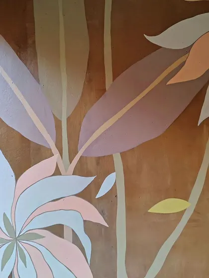 The delicate shapes and colors of the flowers in this earthy mural.