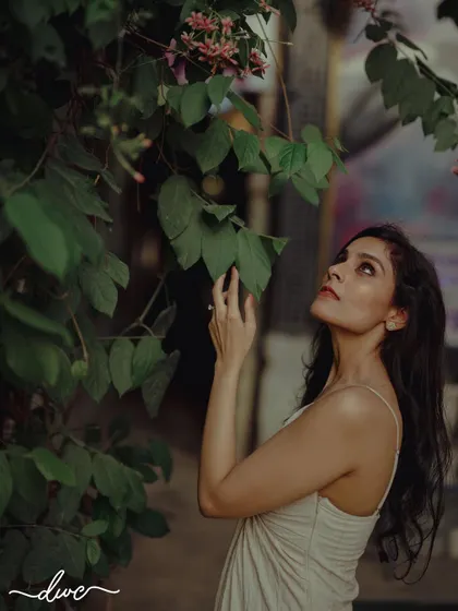 A contemplative and beautiful portrait of the bride-to-be, looking up at the trees, lost in thought before her big day.