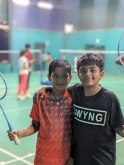 Two of our young players, badminton buddies on and off the court. We pride ourselves on building a strong community where friendships flourish.