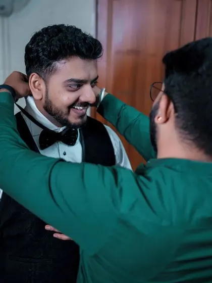 A duplicate of 210, a candid and happy getting-ready moment for the groom.