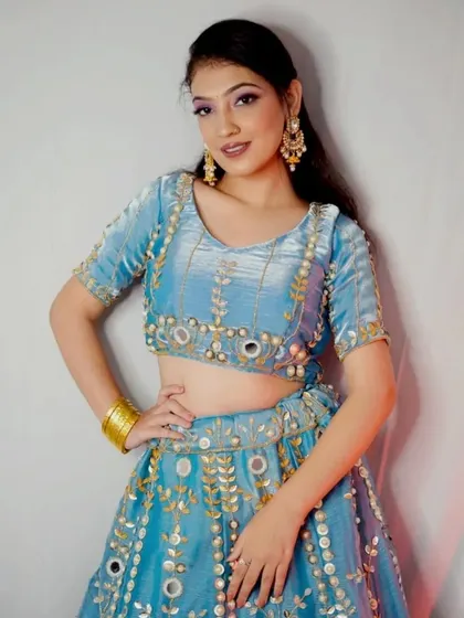 Our client looks absolutely radiant in this blue lehenga. The combination of the rich color and sparkling mirror work is a guaranteed head-turner.