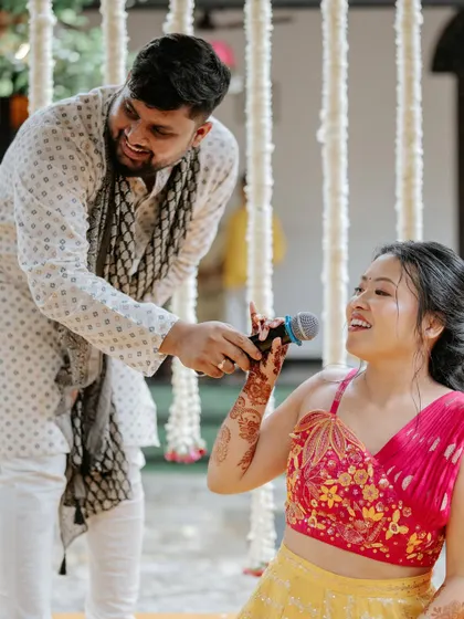 The bride taking the mic to sing or speak during her Haldi, a moment of personal expression we love to facilitate.