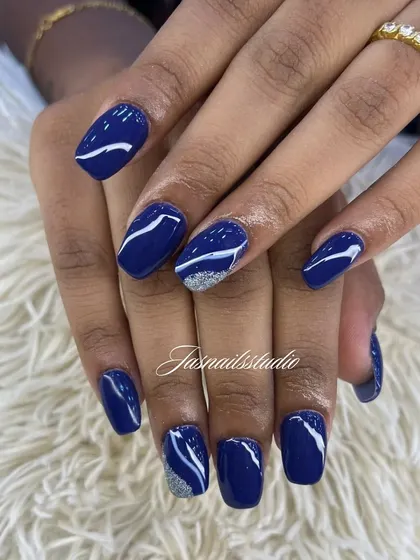A deep navy blue set with abstract white swirls and a silver glitter accent. This design is chic and modern.