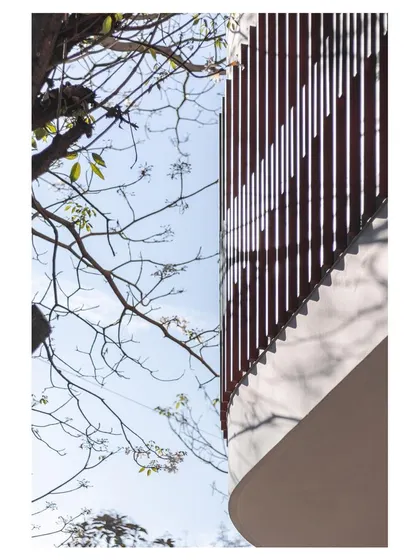 An upward view of the parametric facade, showing how the vertical fins create a wave-like pattern that is both an artistic statement and a functional sun-shading device.