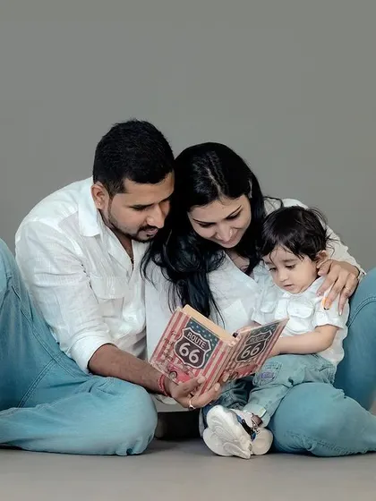 Reading a story together. This posed shot in the studio is a wonderful way to capture a quiet family activity, showing connection and creating a sweet memory.