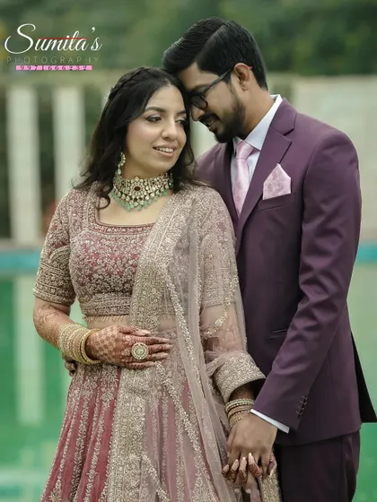 A classic engagement portrait. The couple's coordinated outfits and the serene outdoor setting create an elegant and romantic photograph.