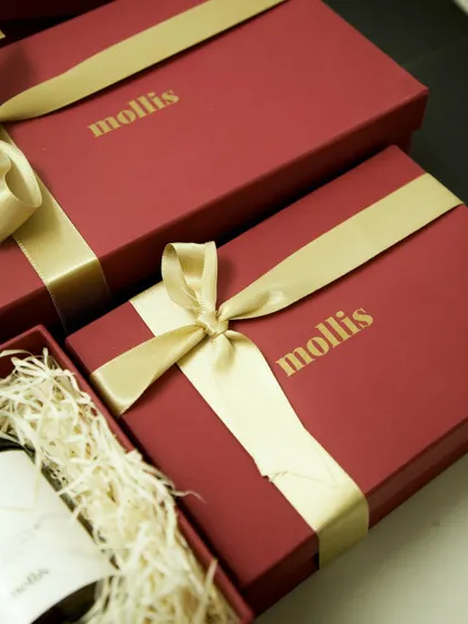 A close-up of my burgundy Diwali gift boxes, tied with a delicate golden ribbon for a touch of festive sophistication.