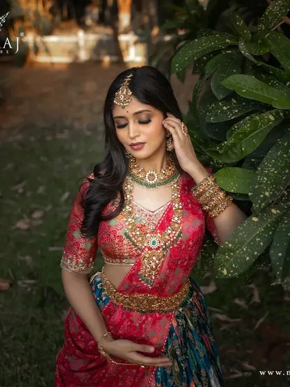 A close-up of the banarasi lehenga, showing the rich texture of the fabric and the intricate jewelry it pairs with.